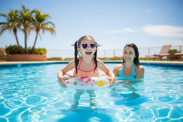 Child using inflatable swim ring in pool